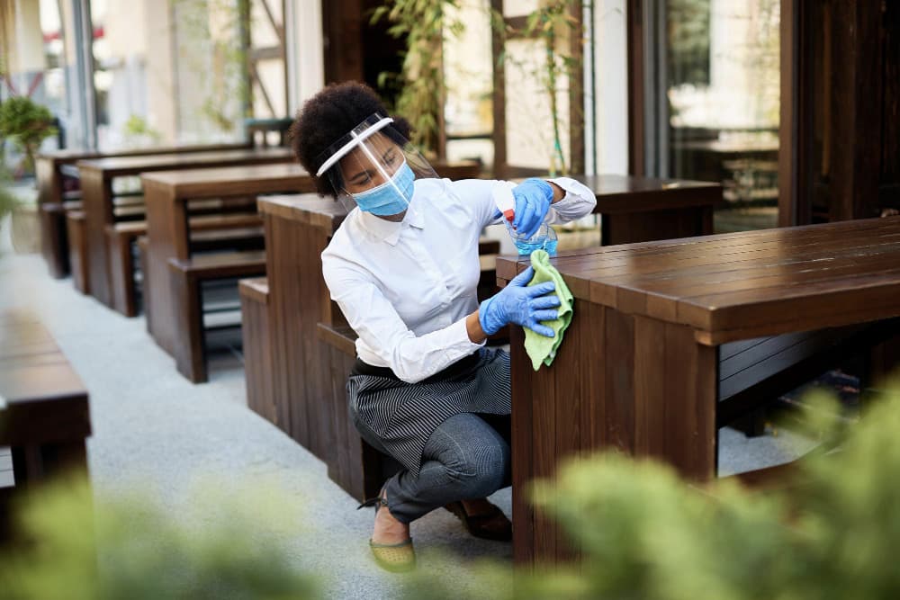 A Cairde Hygienics team member cleaning in protective equipment