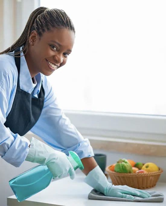 A friendly Cairde Hygienics cleaner working in a home kitchen